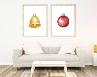 May include: Two framed watercolor illustrations of Christmas ornaments. The first illustration shows a gold bell. The second illustration shows a red Christmas ornament.