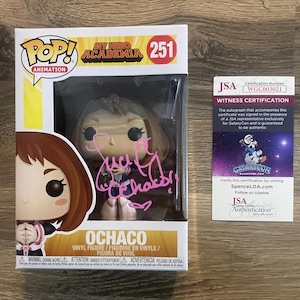 May include: A Funko Pop! Animation figure of Ochaco from My Hero Academia, number 251, in its original box. The figure is autographed in pink ink. A JSA witness certification card is included.