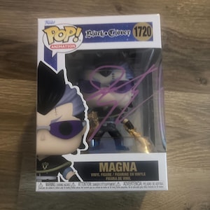 May include: A Funko Pop! vinyl figure of Magna from Black Clover, number 1720. The figure is in its original packaging and features a stylized character with purple hair, sunglasses, and a gold weapon. The box is signed in purple ink.
