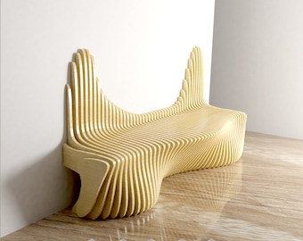 May include: A wooden bench with a unique, wave-like design. The bench is made of multiple layers of wood, creating a layered effect. The bench is in a corner of a room with a white wall and a wooden floor.