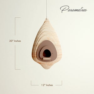 May include: A wooden birdhouse, approximately 20 inches tall and 12 inches wide, with a layered design. The birdhouse has a teardrop shape with a brown interior and a small perch. The text "Parametree" is written in cursive.
