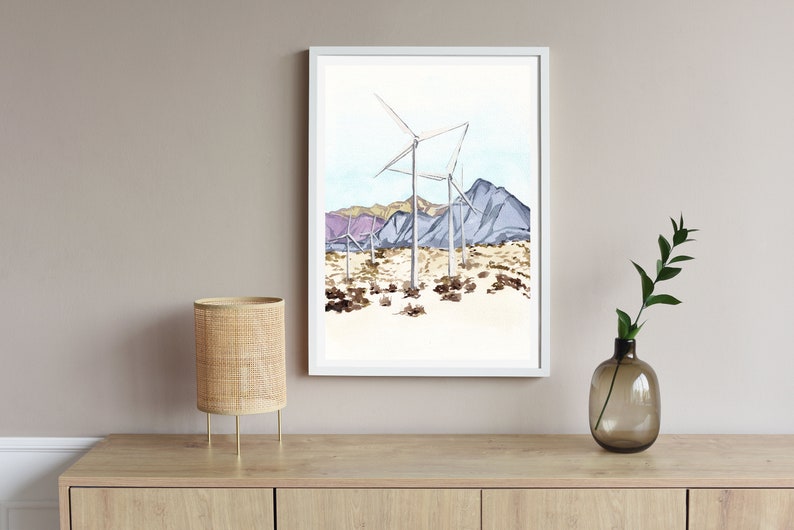 May include: A watercolor painting of wind turbines in a desert landscape with purple mountains in the background.