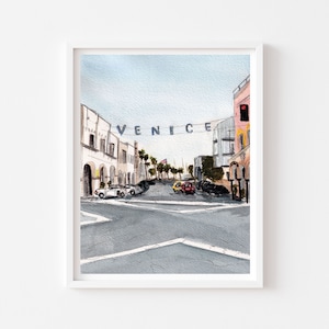 May include: Watercolour painting of a street scene in Venice, California. The street is lined with buildings and palm trees. There are cars driving down the street and a sign that says "VENICE" hanging above the street.