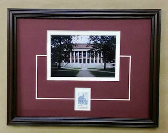 May include: A framed photograph of a building with white columns and a red roof. The building is surrounded by trees and a grassy lawn. The photo is matted in white and burgundy with a smaller photo of the building in the lower right corner.