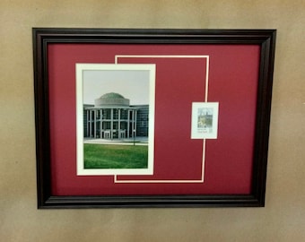May include: A framed photograph of a building with a dome on top. The building is surrounded by green grass. A smaller framed photograph of a building is in the upper right corner of the frame.