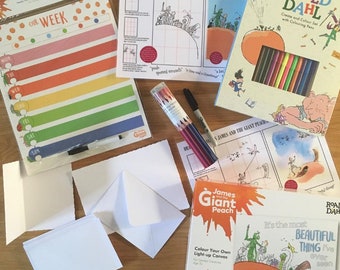 May include: A set of craft supplies for kids featuring the book "James and the Giant Peach" by Roald Dahl. The set includes a magnetic calendar, coloring pages, a light-up canvas, and a set of colored pencils.