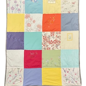 Handmade T-shirt quilt, cozy throw blanket, featuring colorful fabric patches from favorite tees. Perfect for dorm decor, unique gifts, and upcycled home decor. Ideal for college students, T-shirt lovers, or as a warm, soft, machine washable keepsake