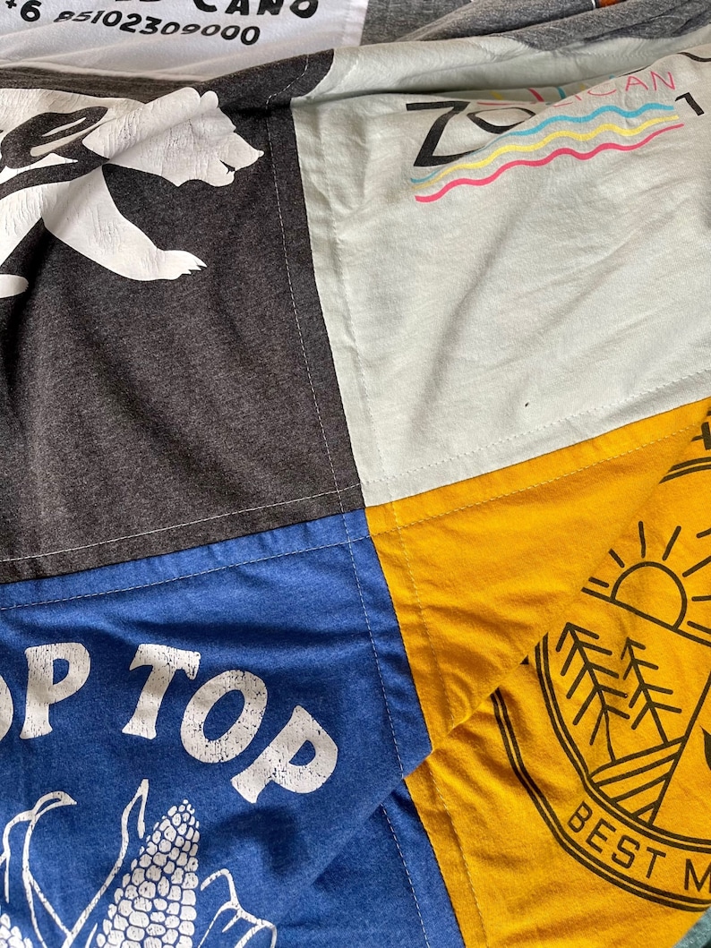 Detail view of quilting stitch on the border of each block of the T Shirt Blanket. #TshirtQuilt
#TshirtBlanket
#QuiltedMemories
#UpcycledQuilt
#CustomQuilt
#MemoryQuilt
#HandmadeQuilt
#QuiltedGift
#CollegeQuilt
#HomeDecor
#CozyBlanket
#SewingProjects
