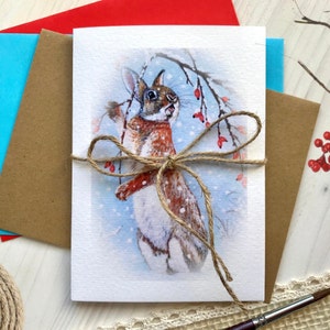 Biglietto di auguri Coniglio Foraggiamento Cinorrodi Neve Fauna selvatica Carta per acquerello Stampa