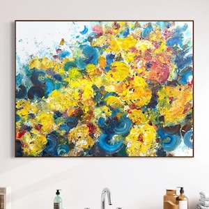 May include: A rectangular canvas painting featuring an abstract composition of thick, textured paint strokes in vibrant shades of yellow, bright blue, deep navy, and touches of red and white, creating a dynamic and layered visual effect.