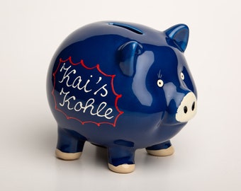 Piggy bank made of ceramic in blue with desired labeling