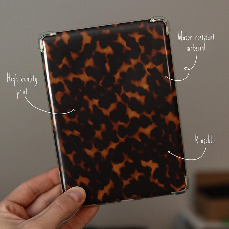 May include: A rectangular case with a tortoiseshell pattern. The case is held in a hand and has clear corner protectors. Text on the image reads "High quality print", "Water resistant material", and "Reusable".