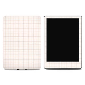 May include: A tablet and a matching case, both featuring a cream-colored grid pattern. The tablet has a black screen, and the case is a solid rectangle. The grid lines are a light brown color.