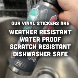 May include: A gray Yeti water bottle with various vinyl stickers on it. The bottle is being rinsed under a faucet. The text "OUR VINYL STICKERS ARE WEATHER RESISTANT WATER PROOF SCRATCH RESISTANT DISHWASHER SAFE" is displayed on the image.