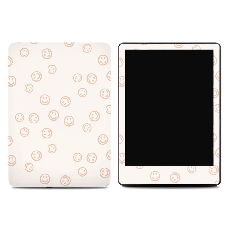 May include: A cream-colored tablet case and a tablet with a black screen. The case and the tablet border are decorated with a repeating pattern of light brown smiley faces. The case is on the left, and the tablet is on the right.