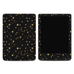 May include: Black e-reader cover and device with a gold star pattern. The cover is on the left, and the e-reader is on the right. The e-reader screen is black.