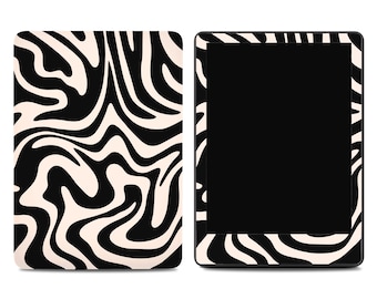 Può includere: Un e-reader nero con un design a stampa zebrata bianca e nera sulla cover e sulla cornice. L'e-reader è mostrato accanto a una cover abbinata con lo stesso motivo zebrato. Lo schermo è nero.
