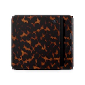 May include: A rectangular tablet with a tortoiseshell pattern in shades of brown and black. The tablet has a camera lens and a black vertical strip on the side. The design resembles a classic tortoiseshell pattern.
