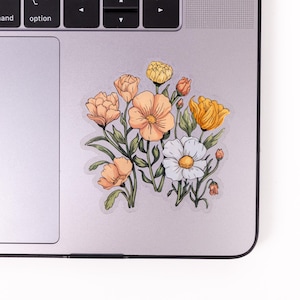 May include: A sticker featuring a bouquet of flowers with orange, yellow, and white petals. The flowers are drawn in a vintage style with green stems and leaves.