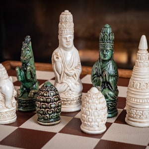 Chess set, Oriental design in an aged green and aged buttermilk. BOARD NOT INCULDED