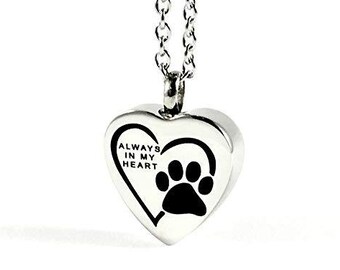May include: Silver heart-shaped pendant necklace with a paw print and the inscription "Always in my heart".