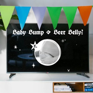 May include: A black and white television screen with the text "Baby Bump or Beer Belly?" in white. A black and white photo of a pregnant belly is in a circle on the screen.
