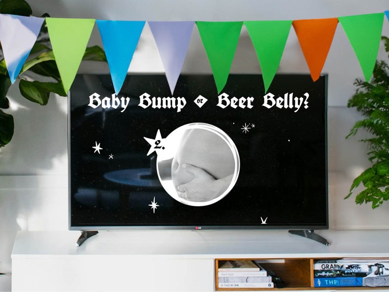 May include: A black and white television screen with the text "Baby Bump or Beer Belly?" in white. A black and white photo of a pregnant belly is in a circle on the screen.