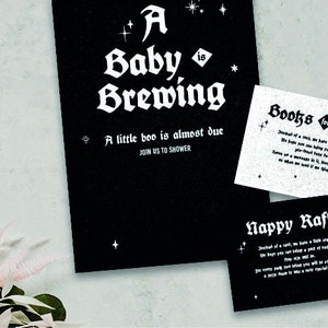 May include: Black and white baby shower invitation with a gothic font. The invitation says "A Baby is Brewing" and "A little boo is almost due. Join us to shower". There are also two smaller cards with the text "Books for Baby" and "Nappy Raffle".
