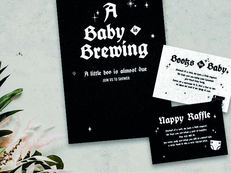 May include: Black and white baby shower invitation with a gothic font. The invitation says "A Baby is Brewing" and "A little boo is almost due. Join us to shower". There are also two smaller cards with the text "Books for Baby" and "Nappy Raffle".