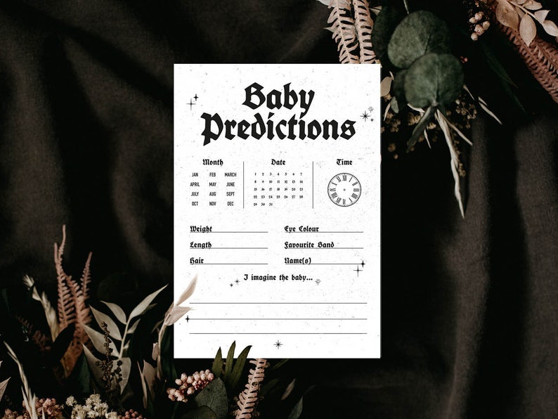 May include: A printable baby predictions card with a black and white gothic font. The card has a calendar, a clock, and spaces to write in the baby's weight, length, hair color, eye color, favorite band, and name. The text on the card reads "Baby Predictions".