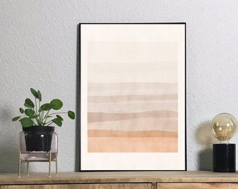 May include: A framed abstract print with a gradient of beige, brown, and orange hues. The print is hanging on a wall above a wooden dresser with a plant in a glass vase and a lamp with a clear glass bulb.