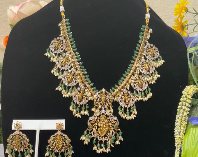 Radiant Gold-Plated Dasavatharam Long Necklace with Green, Ruby and White Stones, and Matching Earrings