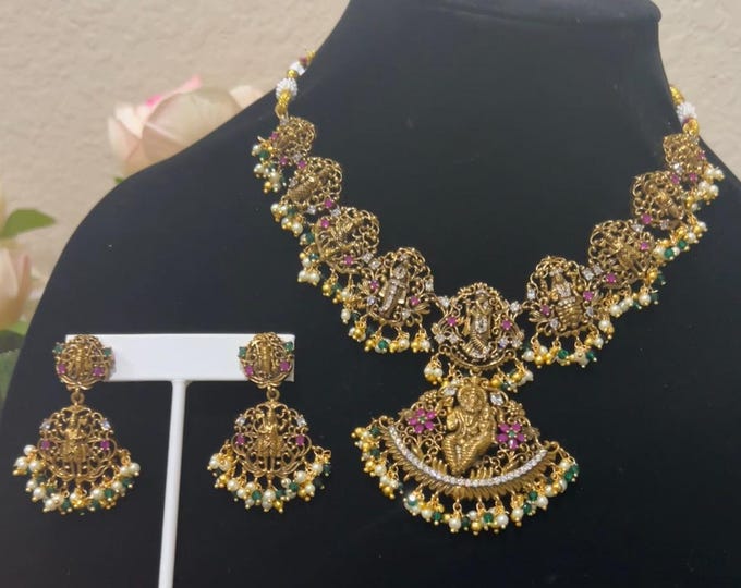Radiant Gold-Plated Dasavatharam Necklace with Green, Ruby and White Stones, and Matching Earrings