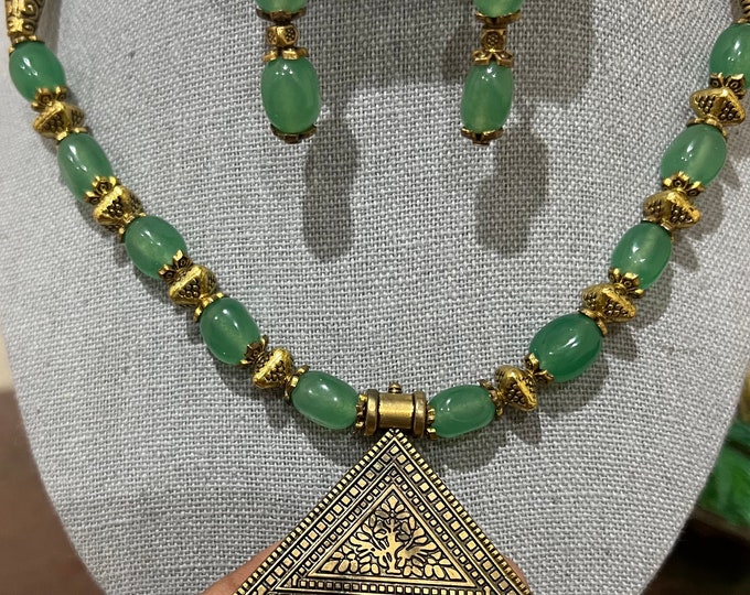 Gorgeous Green beaded Necklace with  gold color  pendant and ear rings .