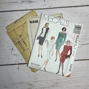 May include: A sewing pattern envelope for a women's suit. The envelope features a photo of three women wearing different versions of the suit. The pattern number is 6348 and the size is D (12, 14, 16).