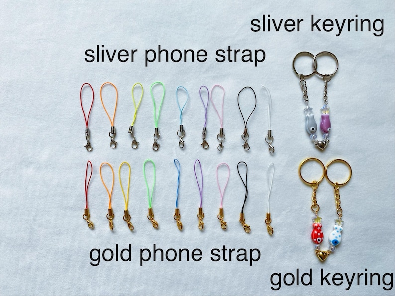 May include: Assortment of colorful phone straps and keychains.  The phone straps are made of thin cord and have silver or gold clasps. The keychains feature small, colorful glass charms.  The text "sliver keyring", "sliver phone strap", "gold phone strap", and "gold keyring" is visible in the image.