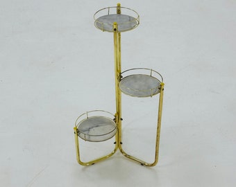 Vintage Flower stand made of brass-colored metal with three marble shelves 1970s