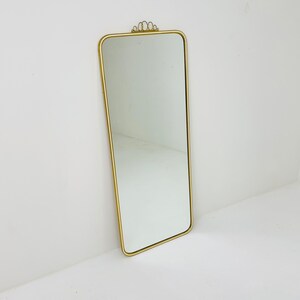 Mid century brass wall mirror with decorative bow 1950s, Italy