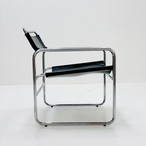 May include: A chrome and black leather lounge chair with a simple, minimalist design.