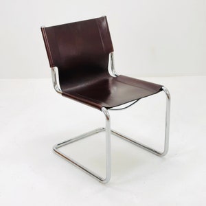 May include: A chrome and brown leather dining chair with a simple, modern design.