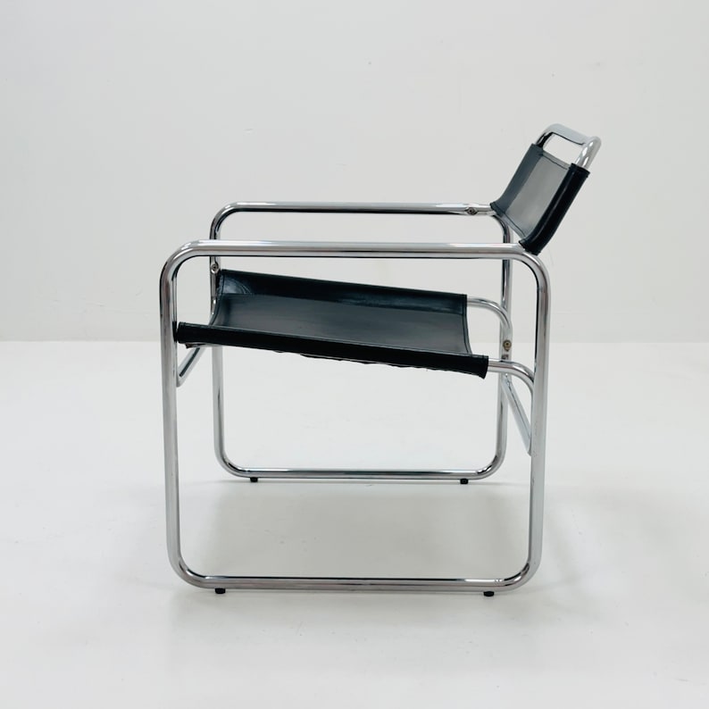 May include: A black leather and chrome chair with a simple, modern design.