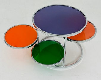 chrome and colorful glass coffee table with 3 swiveling tiers by Kare design