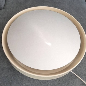 Sweden wall mirror backlit with a cream plastic frame, made in the 1970s