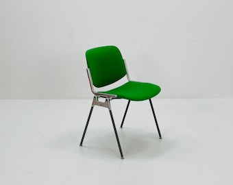 May include: A green upholstered chair with a metal frame. The chair has a simple design with four legs and a slightly curved back.
