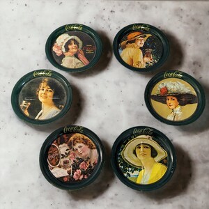 Vintage Coca-Cola advertising metal drink coasters — 1983 The Coca-Cola Company