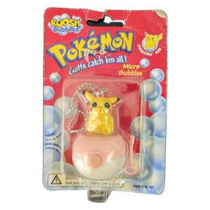 May include: A yellow Pikachu Pokemon character keychain with a pink and white bubble blower. The packaging says "Gotta catch 'em all!" and "Micro Bubbles".
