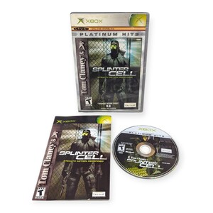 May include: An Xbox video game, "Tom Clancy's Splinter Cell: Stealth Action Redefined," in its original packaging. The game case, insert, and disc are visible, featuring a character in tactical gear. The game is rated "T" for Teen.
