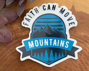 May include: A white sticker with a blue and black mountain scene. The text "Faith Can Move Mountains" is written around the mountain scene.