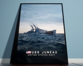 May include: A black and white photo of the USS Juneau, a United States Navy cruiser, sailing on a choppy sea. The ship is camouflaged with a dark gray paint scheme. The image is framed in a black frame. The text "USS JUNEAU UNITED STATES NAVY" is printed below the image.