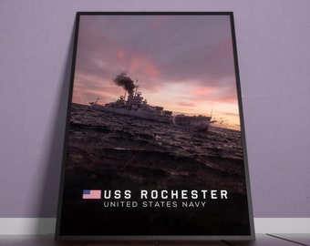 May include: A black and white photograph of the USS Rochester, a United States Navy cruiser, sailing on the ocean at sunset. The ship is silhouetted against a dramatic sky with a thick plume of smoke rising from its funnel. The text "USS ROCHESTER UNITED STATES NAVY" is displayed at the bottom of the image.